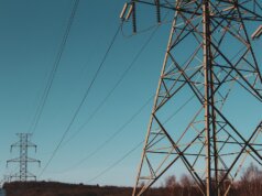 brown electric post under blue sky during daytime