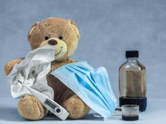 brown bear plush toy on blue textile