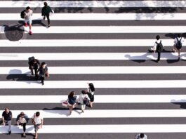 aerial view photography of group of people walking on gray and white pedestrian lane