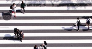 aerial view photography of group of people walking on gray and white pedestrian lane