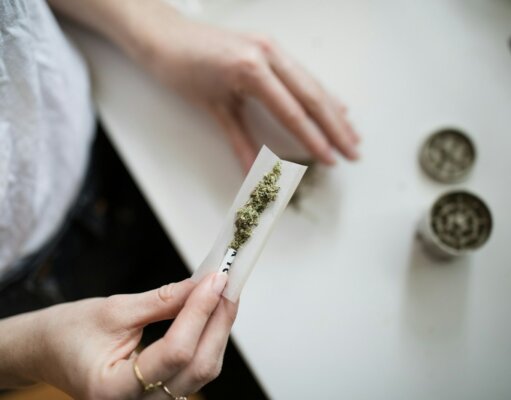 person making cannabis joint