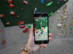 a person taking a picture of a climbing wall