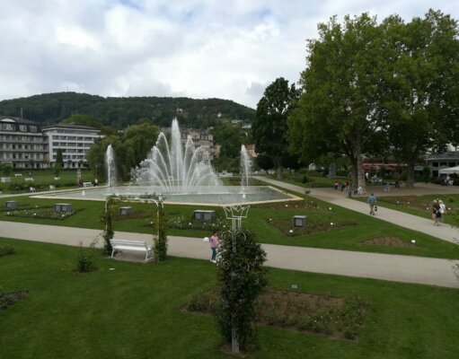 a park with a fountain in the middle of it