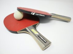two red pingpong rackets on white surface