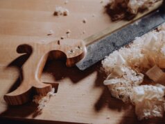 a knife and some wood shavings on a table