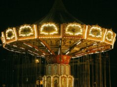 a merry go round at night with lights on it