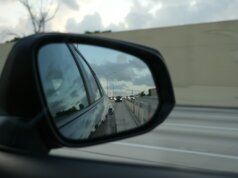 A rear view mirror on the side of a car