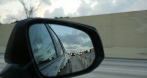 A rear view mirror on the side of a car